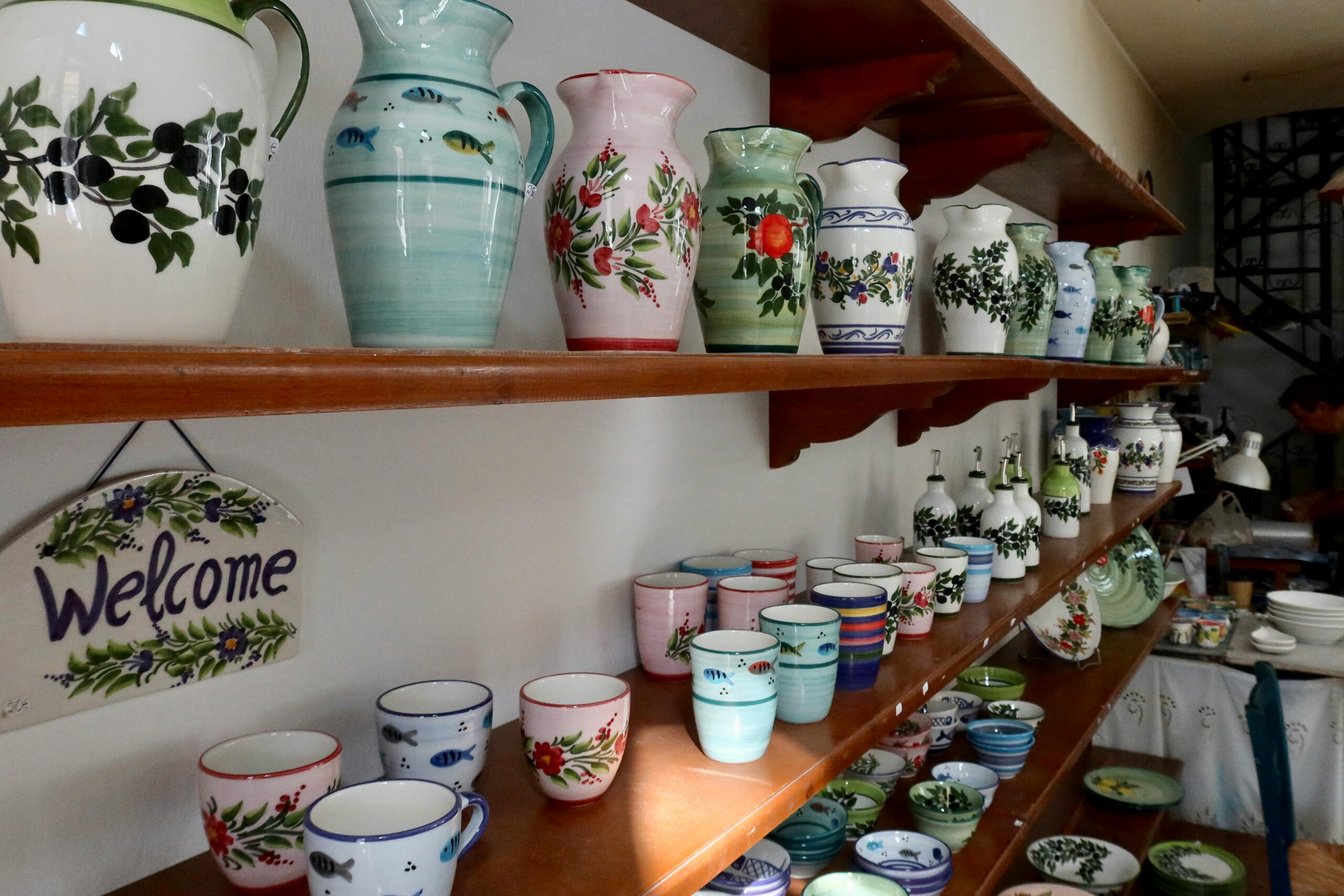 Vibrant handmade pottery displayed in a shop in Pythagoreio, Greece. Perfect for decor lovers.